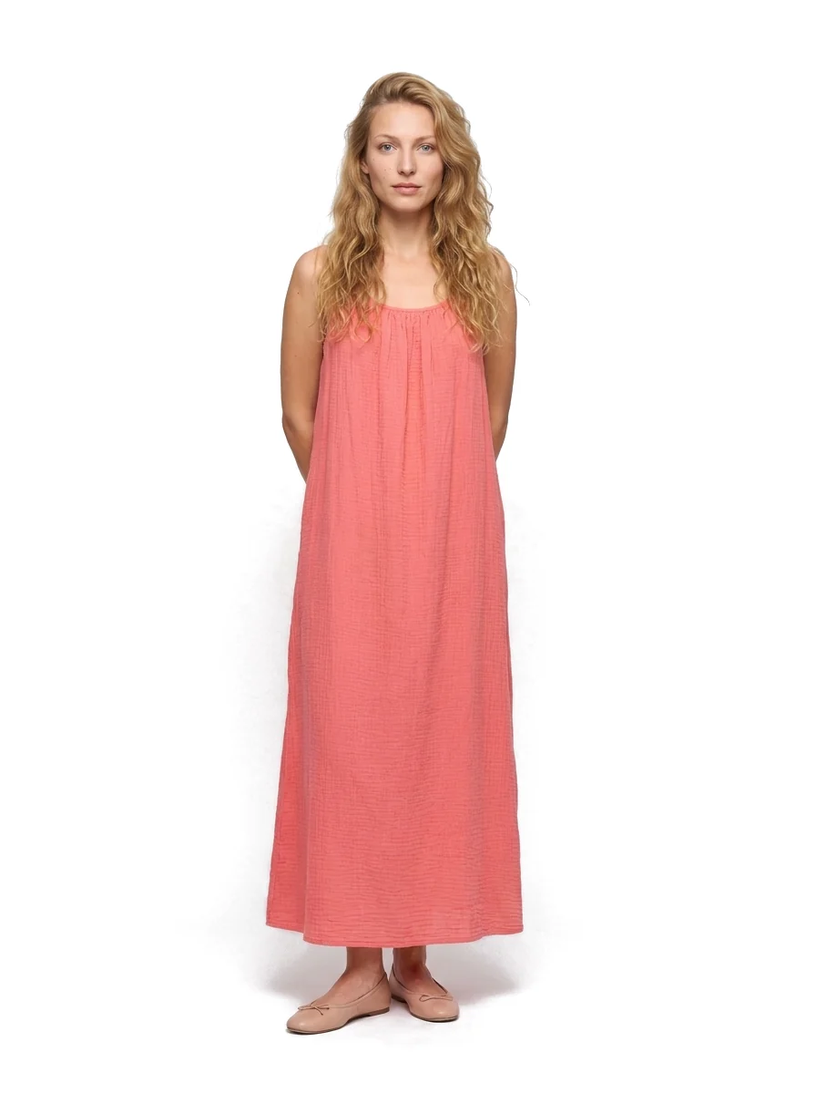 Model wearing the coral maxi dress in a white studio setting